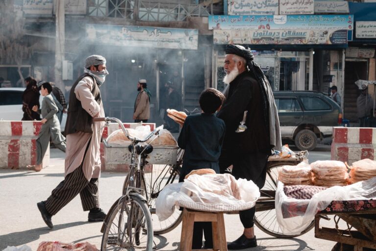 Street vendors and shoppers in a busy market in Kunduz, Afghanistan.