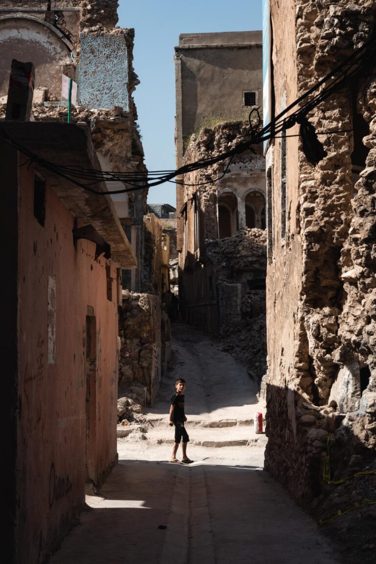 Narrow dark alley in Mosul showing remnants of war’s devastation