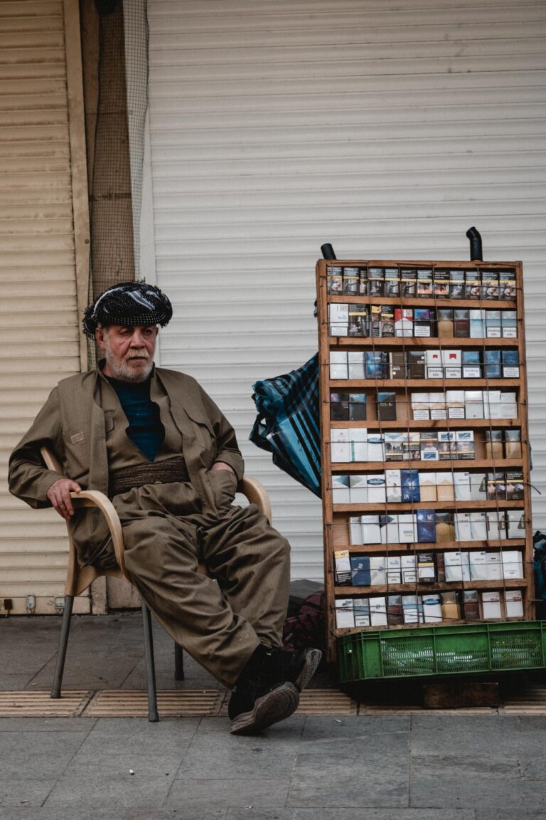 Man near a newspaper stand showcasing daily publications in Erbil, Kurdistan