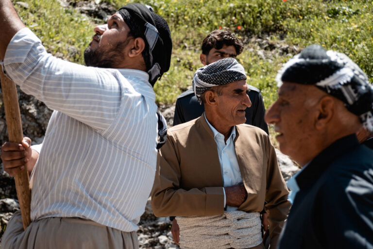 Sufi men engaged in conversation during a spiritual gathering in Akre, Kurdistan