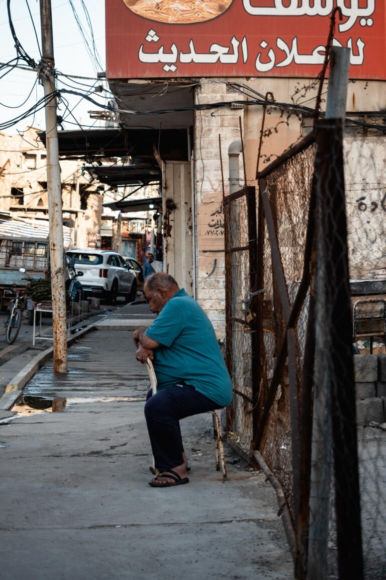 Man sitting pensively in the destroyed alleyways of old Mosul, Iraq