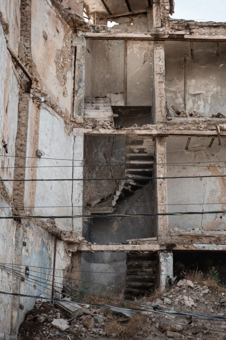 Crumbling façade of a bombed building in post-war Mosul