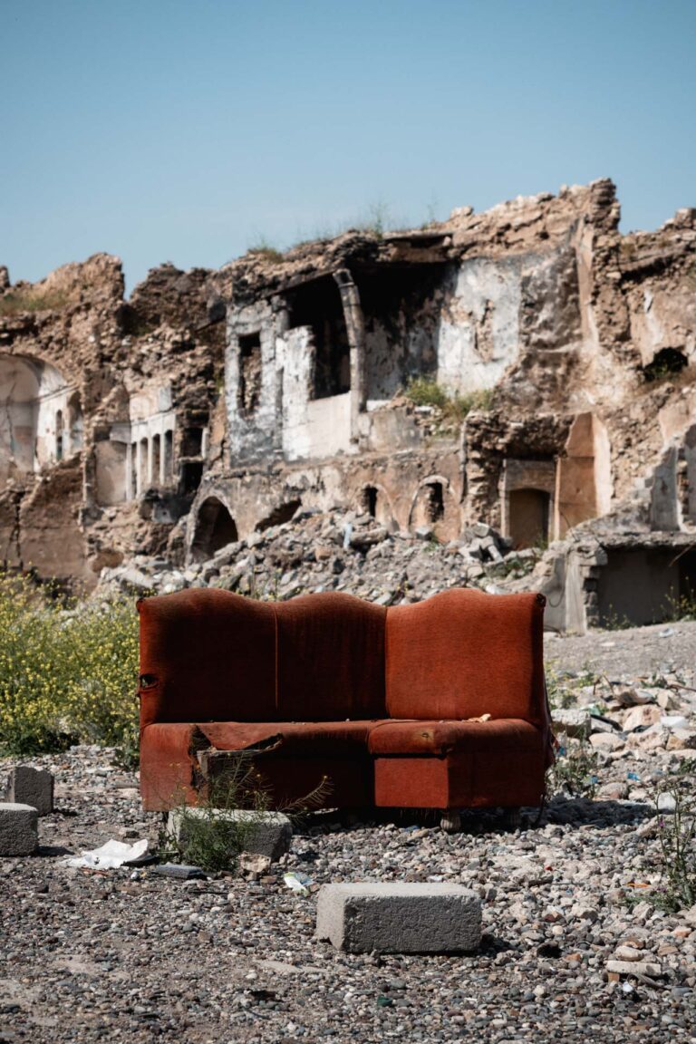Abandoned sofa reflecting destruction and loss in Mosul after conflict