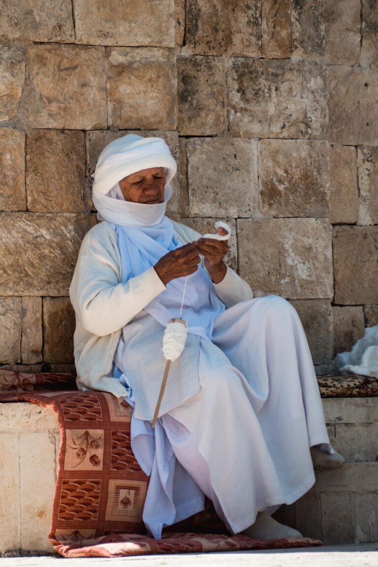 Yazidi woman weaving cotton at the sacred Lalish temple, a spiritual Yazidi site