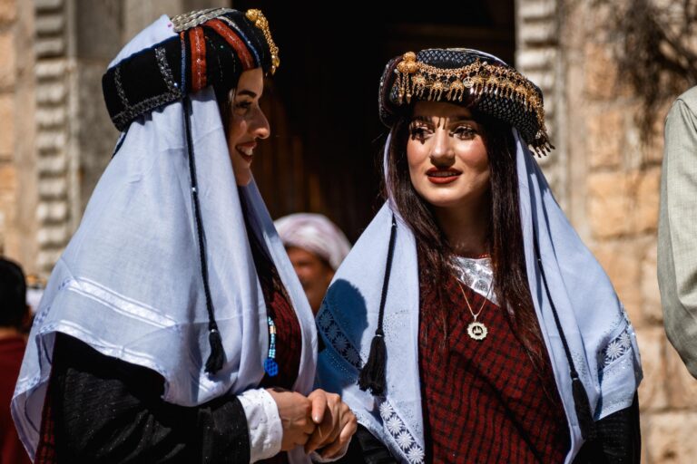 Yazidi women in cultural attire during a ceremony at Lalish temple, Kurdistan