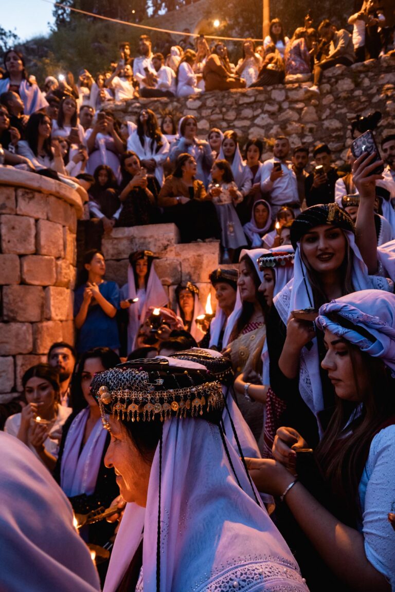 Night Yazidi ceremony with candles illuminating Lalish temple during rituals