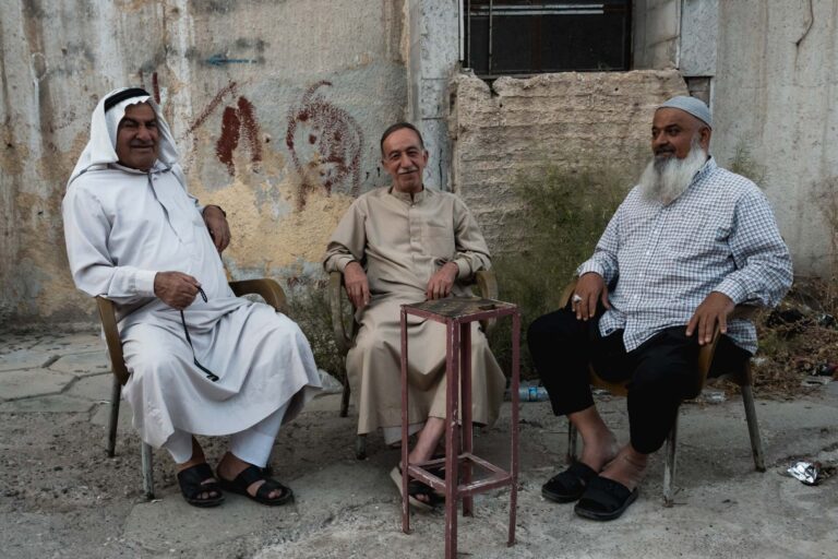 Group of elderly men socializing in a traditional Iraqi café in Mosul