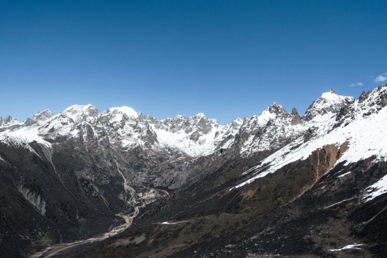 Dramatic mountain landscape with snow peaks, Sicuan Tibet China.