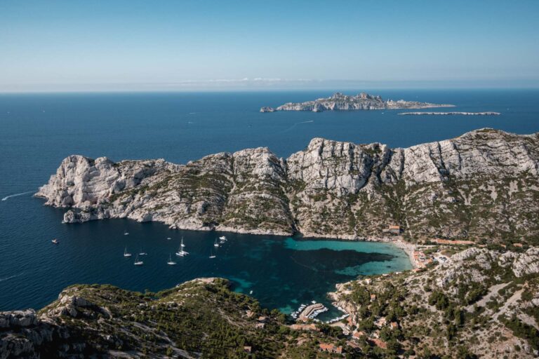 Emerald waters of En Vau calanque surrounded by limestone cliffs in France