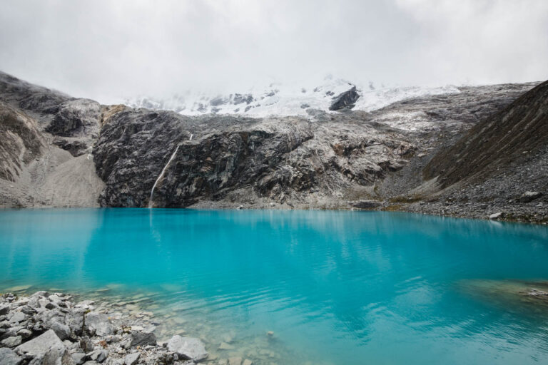 Turquoise Laguna 69 surrounded by snowy peaks in Huaraz, Peru