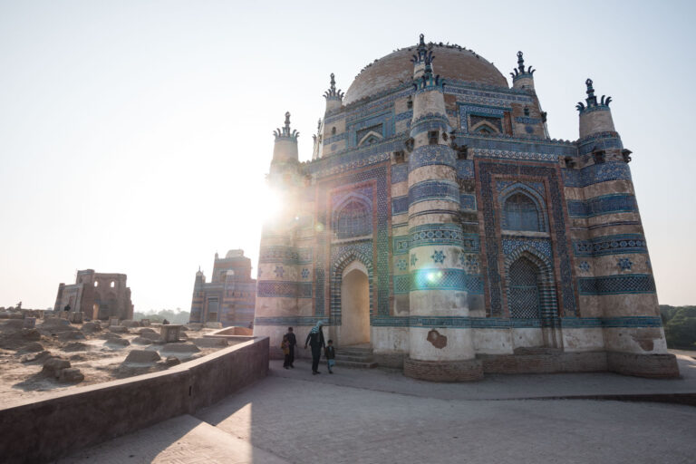 he ornate and blue-tiled dome of the historic Bibi Jawindi Tomb in Uch Sharif, Pakistan.