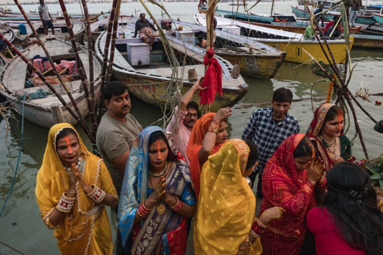 oyful group of women and children celebrating near the riverbanks in Varanasi, India.