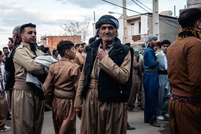 Kurdish man wearing traditional clothing standing outdoors in Kurdistan, Iran.
