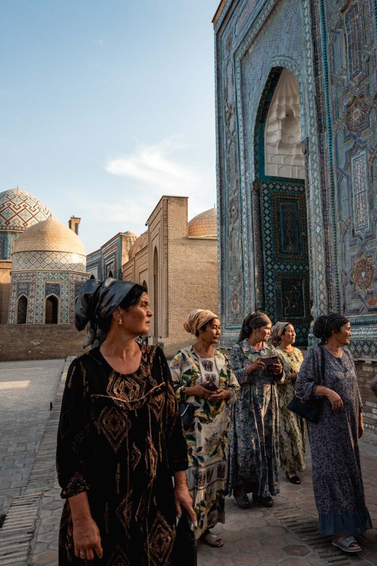group of women walking through the stunning blue-tiled mausoleum complex in Samarkand.