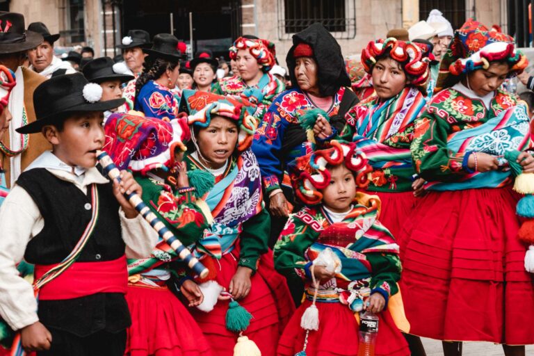 Andean dancers in red and white costumes performing during the Fiesta de la Candelaria.