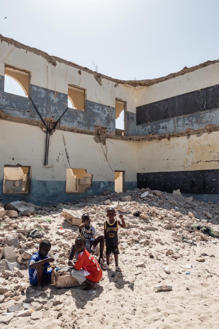Senegalese children playing in front of the ruins of their school, which collapsed due to rising waters, in Saint-Louis, Senegal